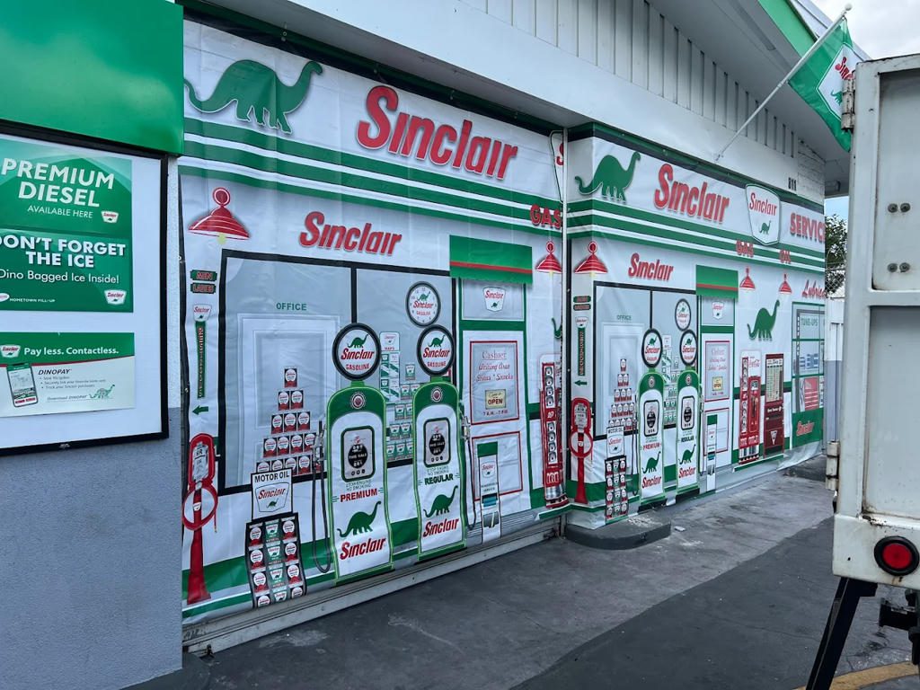 Storefront wrapped in Sinclair dinosaur graphics